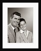 1950s Studio Portrait Smiling Man Father And Boy Son Sitting Together Looking At Camera by Anonymous