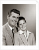 1950s Studio Portrait Smiling Man Father And Boy Son Sitting Together Looking At Camera by Anonymous