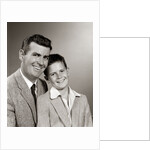 1950s Studio Portrait Smiling Man Father And Boy Son Sitting Together Looking At Camera by Anonymous