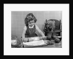 1950s Little Girl Rolling Out Apple Pie Crust On Kitchen Table With Cocker Spaniel Puppy Watching by Anonymous