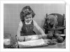 1950s Little Girl Rolling Out Apple Pie Crust On Kitchen Table With Cocker Spaniel Puppy Watching by Anonymous