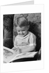 1930s 1940s Little Boy Sitting On Chair Reading Picture Book by Anonymous