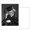 1950s Little Blond Girl Wearing Scholarly Glasses Graduation Cap And Gown Looking At Camera by Anonymous