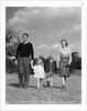 1940s Family Father Mother Son Daughter Holding Hands Together Walking On Grass by Anonymous
