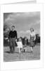 1940s Family Father Mother Son Daughter Holding Hands Together Walking On Grass by Anonymous