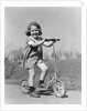 1930s Smiling Girl Playing On Scooter On Sidewalk Looking At Camera by Anonymous
