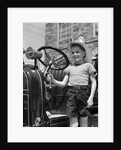 1930s Smiling Boy Standing Next To Fire Engine Wearing Firemans Hat by Anonymous
