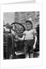 1930s Smiling Boy Standing Next To Fire Engine Wearing Firemans Hat by Anonymous