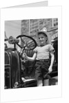 1930s Smiling Boy Standing Next To Fire Engine Wearing Firemans Hat by Anonymous