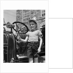 1930s Smiling Boy Standing Next To Fire Engine Wearing Firemans Hat by Anonymous