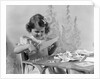 1940s Smiling Little Girl Cutting Paper With Scissors by Anonymous