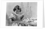1940s Smiling Little Girl Cutting Paper With Scissors by Anonymous