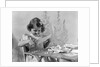 1940s Smiling Little Girl Cutting Paper With Scissors by Anonymous