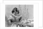 1940s Smiling Little Girl Cutting Paper With Scissors by Anonymous