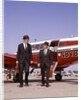 1960s Two Businessmen In Suits And Hats Carrying Briefcases Walking From A Small Twin Prop Business Airplane Talking by Anonymous