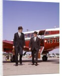 1960s Two Businessmen In Suits And Hats Carrying Briefcases Walking From A Small Twin Prop Business Airplane Talking by Anonymous