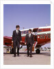 1960s Two Businessmen In Suits And Hats Carrying Briefcases Walking From A Small Twin Prop Business Airplane Talking by Anonymous