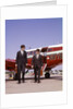 1960s Two Businessmen In Suits And Hats Carrying Briefcases Walking From A Small Twin Prop Business Airplane Talking by Anonymous