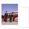 1960s Two Businessmen In Suits And Hats Carrying Briefcases Walking From A Small Twin Prop Business Airplane Talking by Anonymous