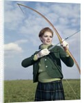 1960s 1970s Sports Woman Archer Holding Bow Preparing To Draw Arrow by Anonymous