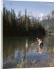 1970s Man Fisherman Red Shirt In Rocky Mountains Stream Lake Fly Rod Catch Splashing On Line Net by Anonymous