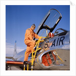 1960s 1970s Smiling Military Pilot Ladder Climbing Enter Cockpit Looking At Camera by Anonymous
