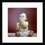 1940s 1950s Baby Diaper Sitting Looking Up Fingers In Mouth by Anonymous