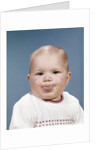 1960s Portrait Of Cute Blond Chubby Baby Looking At Camera Sticking Out Tongue by Anonymous