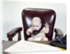 1960s Chubby Baby Sitting In Leather Office Chair Behind Desk Holding Talking On Telephone by Anonymous