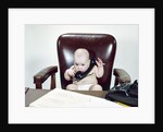 1960s Chubby Baby Sitting In Leather Office Chair Behind Desk Holding Talking On Telephone by Anonymous