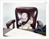 1960s Chubby Baby Sitting In Leather Office Chair Behind Desk Holding Talking On Telephone by Anonymous