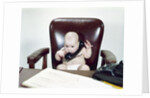 1960s Chubby Baby Sitting In Leather Office Chair Behind Desk Holding Talking On Telephone by Anonymous