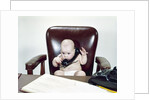 1960s Chubby Baby Sitting In Leather Office Chair Behind Desk Holding Talking On Telephone by Anonymous