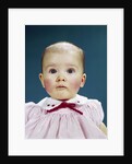 1960s Portrait Baby Girl Silly Facial Expression Red Bow At Collar Looking At Camera by Anonymous