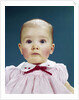 1960s Portrait Baby Girl Silly Facial Expression Red Bow At Collar Looking At Camera by Anonymous