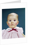 1960s Portrait Baby Girl Silly Facial Expression Red Bow At Collar Looking At Camera by Anonymous