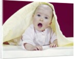 1960s Baby Mouth Wide Open Peeking Out From Under Yellow Blanket Looking At Camera by Anonymous