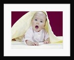 1960s Baby Mouth Wide Open Peeking Out From Under Yellow Blanket Looking At Camera by Anonymous