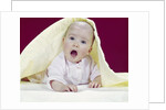 1960s Baby Mouth Wide Open Peeking Out From Under Yellow Blanket Looking At Camera by Anonymous