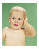 1960s Smiling Happy Baby Looking Off To The Side With Hand Touching Face by Anonymous