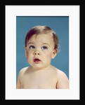 1960s Baby With Uncertain Facial Expression Deep Blue Eyes Looking Guilty Up And To The Side by Anonymous