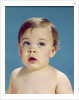 1960s Baby With Uncertain Facial Expression Deep Blue Eyes Looking Guilty Up And To The Side by Anonymous