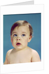 1960s Baby With Uncertain Facial Expression Deep Blue Eyes Looking Guilty Up And To The Side by Anonymous