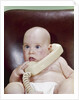 1960s Chubby Baby Sitting In Leather Office Chair Talking On Telephone by Anonymous