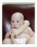 1960s Chubby Baby Sitting In Leather Office Chair Talking On Telephone by Anonymous