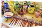 Paint brushes and colored paints by Anonymous