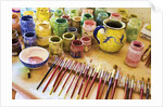 Paint brushes and colored paints by Anonymous