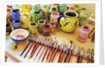 Paint brushes and colored paints by Anonymous