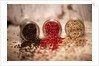 Black, red, and white pepper corns in rustic mason jars by Anonymous
