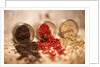 Black, red, and white pepper corns in rustic mason jars by Anonymous